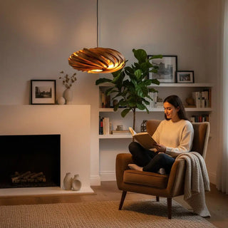 Gofurnit Veneria pendant lamp made of natural amberwood with a swirling, layered design. Warm light glows through the wood.